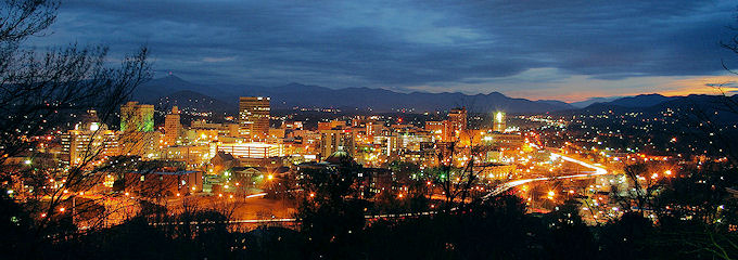 Asheville home architects enjoy the night life and excitement of a big town while being near to the mountains (in the background).
